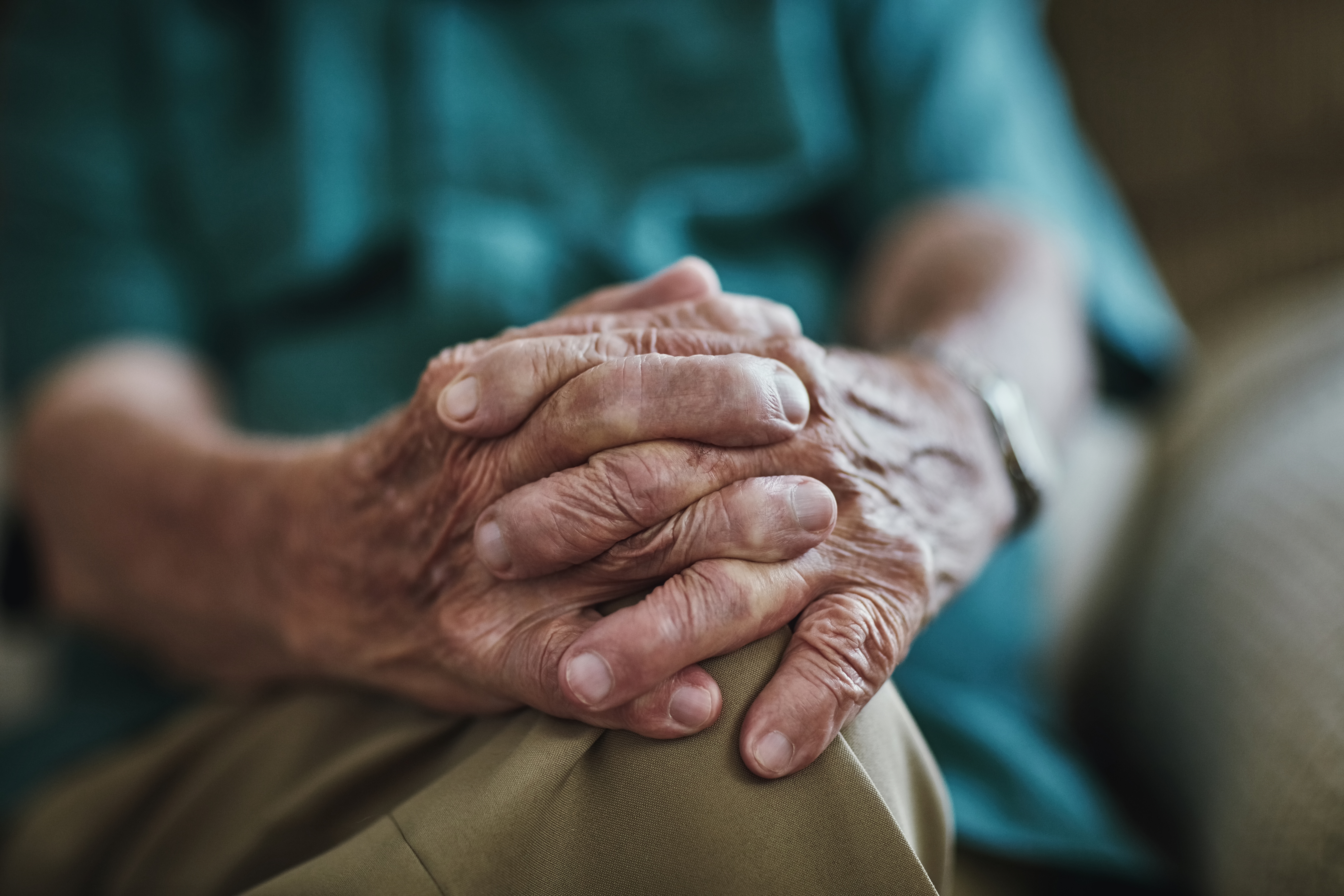 Senior man with hands together