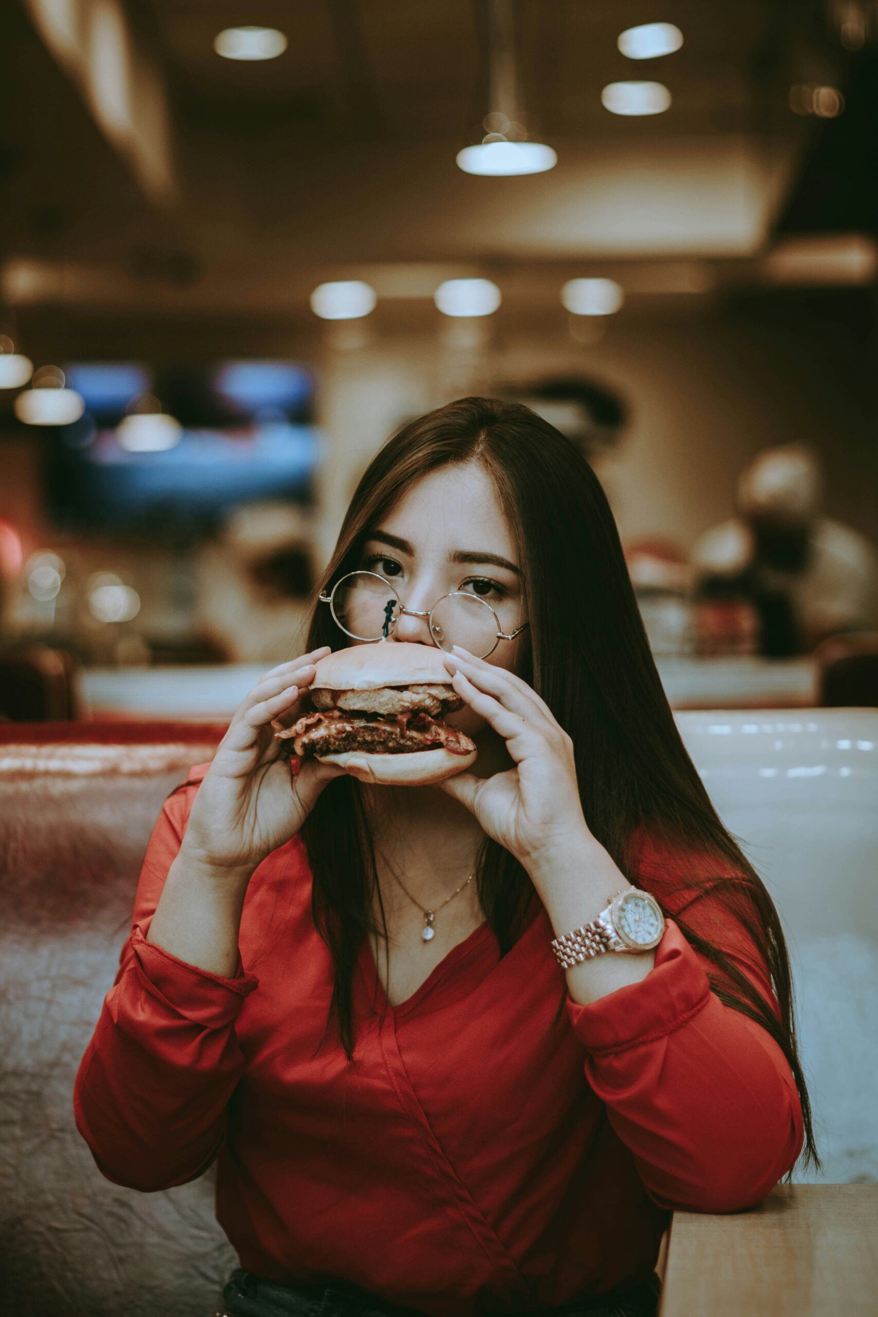 Young woman eating junk food